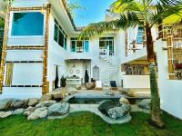 a house with a swimming pool and a palm tree at Pupah Kanna Pua-ปู๋ ป๋าล์ คันนา ปัว in Pua