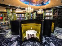 a dining room with a table and chandeliers at Walker's Bluff Casino Resort in Carbondale