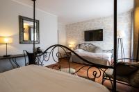 a bedroom with two beds and a mirror at Best Western L&#39;Orangerie in Nîmes