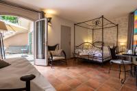 a bedroom with a wrought iron bed and a patio at Best Western L&#39;Orangerie in Nîmes