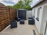 a patio with chairs and a fence with a gate at Maison entre Paris et Disney in Pontault-Combault