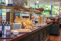 a buffet line with pastries and other food items at Trans World Hotel Donauwelle in Linz