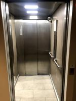 a metal elevator in a bathroom with a tile floor at Jolie chambre à Nanterre Préfecture proche La Défense Aréna Campus SNCF et Paris in Nanterre