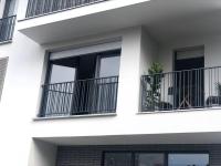 a white building with windows and a plant on a balcony at Jolie chambre à Nanterre Préfecture proche La Défense Aréna Campus SNCF et Paris in Nanterre