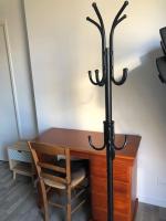 a wooden table with a black candlesticks next to a desk at Jolie chambre à Nanterre Préfecture proche La Défense Aréna Campus SNCF et Paris in Nanterre