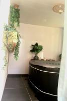 a room with plants on the wall and a table at Charmant duplex avec jacuzzi in Aumelas