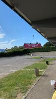 an empty parking lot with a building in the background at Premiere Classe Quimper in Quimper