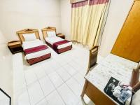 Postel nebo postele na pokoji v ubytování Al Ghadeer Hotel Apartment