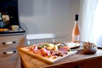 a plate of food on a table with a bottle of wine at La Brocante - Meilleurhote-Brioude in Brioude