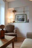 a living room with a table and a chair at La Brocante - Meilleurhote-Brioude in Brioude