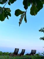 two chairs on the beach with the ocean in the background at Bridge12th B&amp;B in Yanliau