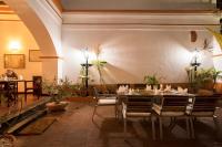 a dining room with a table and some plants at Dune de L'orient in Puducherry