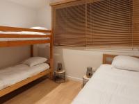 a bedroom with two bunk beds and a window at L’Arabesque, villa de charme avec piscine in Arradon