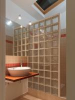 a bathroom with a sink and a wall of glass blocks at L’Arabesque, villa de charme avec piscine in Arradon