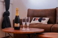 a bottle of champagne and two glasses on a table at Villa Corbelle - Grand Studio in Cannes