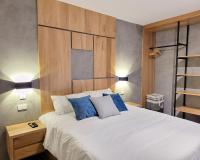 a bedroom with a large white bed with blue pillows at Center City Flats - Apartments in El Poblado near Park Lleras, Medellin! in Medellín