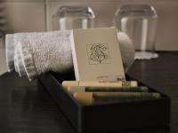 a box of books on a table with a towel at Amicitia - Hôtel &amp; Restaurant in LʼIsle-Adam