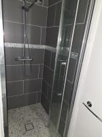 a bathroom with a shower with a glass door at Au cœur de Caillassou in Villemur-sur-Tarn