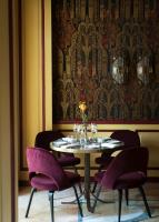 a dining room with a table and purple chairs at Grand Hotel et de Milan - The Leading Hotels of the World in Milan