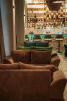 a row of couches in a room with a bar at Hotel Piano Kvareli in Kvareli