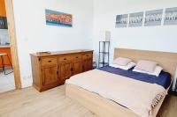 a bedroom with a bed and a wooden dresser at La Villa Marine*Familiale et Conviviale in Coudekerque-Branche
