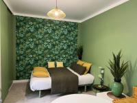 a bedroom with a bed with a large green wall at L&#39;Oasis urbaine : détente totale in La Rochelle