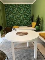 a white table in a room with a green wall at L&#39;Oasis urbaine : détente totale in La Rochelle