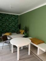 a living room with a white table and a couch at L&#39;Oasis urbaine : détente totale in La Rochelle