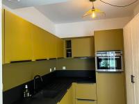 a kitchen with yellow and green cabinets and a sink at L&#39;Oasis urbaine : détente totale in La Rochelle