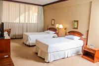 Rúm í herbergi á Nobile Suites Excelsior Asuncion