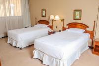 Rúm í herbergi á Nobile Suites Excelsior Asuncion