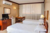 Rúm í herbergi á Nobile Suites Excelsior Asuncion