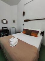 a bedroom with a bed with two towels on it at Pousada São Francisco in Cumuruxatiba