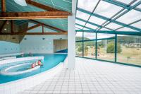 a swimming pool with people in the water at Camping Les Vosges du Nord in Oberbronn