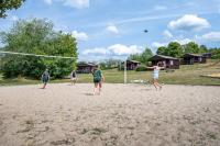 a group of people playing volleyball on a beach at Camping Les Vosges du Nord in Oberbronn