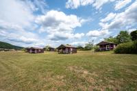 a group of cottages in a grassy field at Camping Les Vosges du Nord in Oberbronn