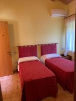 A bed or beds in a room at Taverna dei Guelfi