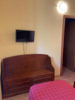 A bed or beds in a room at Taverna dei Guelfi