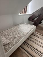 a bed sitting on the floor in a room at Le Petit Port in Sedan