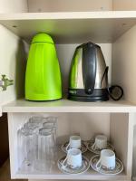 a tea pot and cups on a shelf at Chez les deux garçons in Montrouge