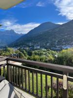 a view of the mountains from the balcony of a house at Appartement cosy, esprit chalet avec jolie vue in Saint-Gervais-les-Bains