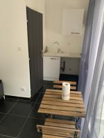 a room with a table with a roll of toilet paper on it at Jolie maisonnette avec terrasse Nancy centre in Nancy