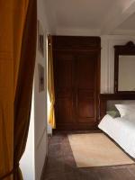 a bedroom with a bed and a wooden door at Bel appartement neuf, cosy et d’époque aux Vans in Les Vans