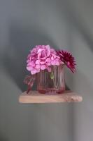a vase of pink flowers sitting on a shelf at Le Perchoir Gîte de charme dans château in Brix