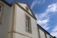 a building with a window on the side of it at Le Perchoir Gîte de charme dans château in Brix