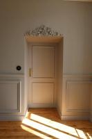 an empty room with a door and rays of light at Le Perchoir Gîte de charme dans château in Brix