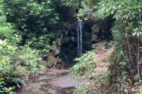 a waterfall in the middle of a trail at Le Perchoir Gîte de charme dans château in Brix