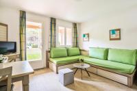 a living room with green couches and a tv at Résidence Saint-Raphaël Valescure - maeva Home - Studio 2 personnes - Séle 41 in Valescure