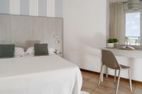 A bed or beds in a room at Hotel Roxy & Beach
