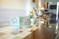 a blue box with flowers on a counter in a kitchen at Blue Cotton Candy B&amp;B in Taitung City